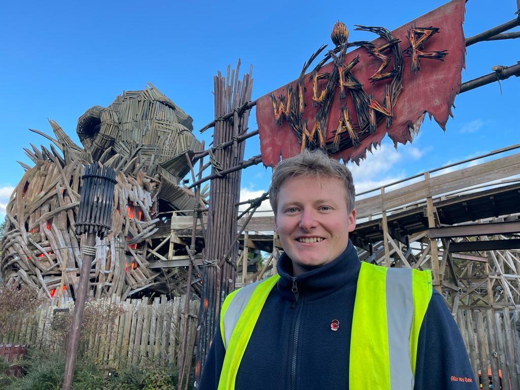 Russ standing in front of the Wicker Man attraction