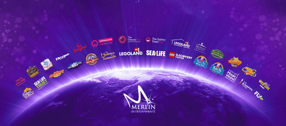 A purple globe is surrounded by a series of logos from the Merlin Entertainment portfolio such as Alton Towers Resort, SEA LIFE, Thorpe Park and The Dungeons