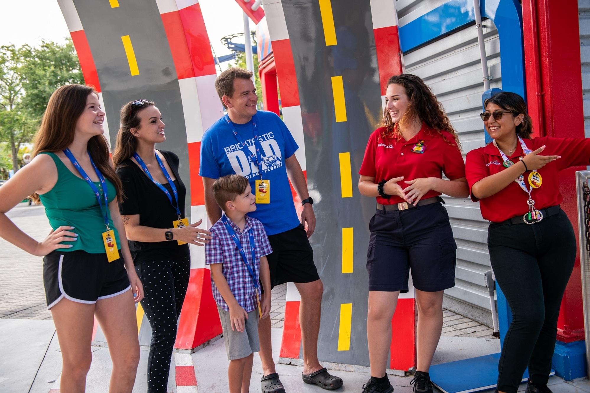 LEGOLAND teammates welcoming guests into the park. Guests and teammates are smiling